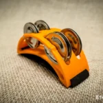 Spider percussion tambourine with foot mounting