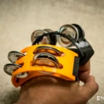 Spider percussion tambourine with foot mounting