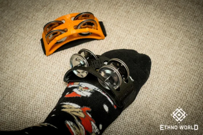 Spider percussion tambourine with foot mounting