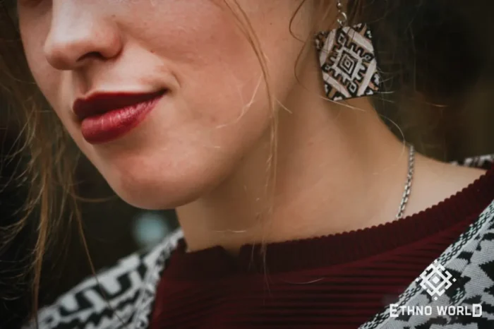 Model wearing handmade green carved earrings