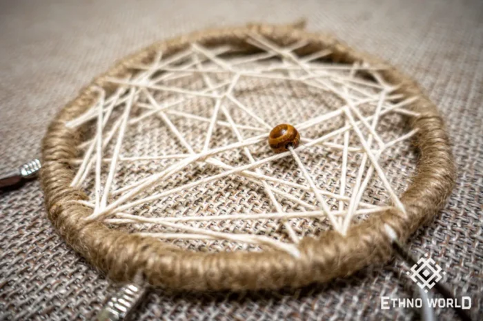 Small handwoven dreamcatcher with feather and bead details, tribal boho wall decoration, Ethno World