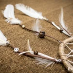 Small handwoven dreamcatcher with feather and bead details, tribal boho wall decoration, Ethno World