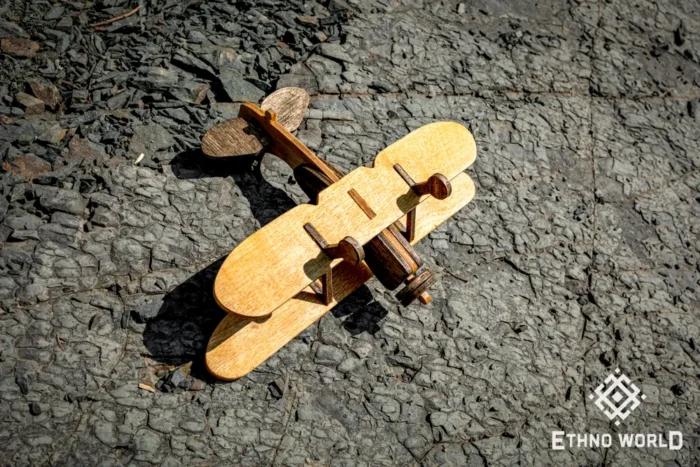 Wooden airplane toy, assembled model, side view