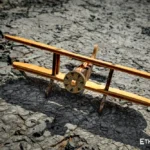 Handmade wooden biplane model on stone background